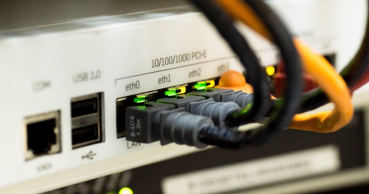 close-up of network router with Ethernet cables connected to ports